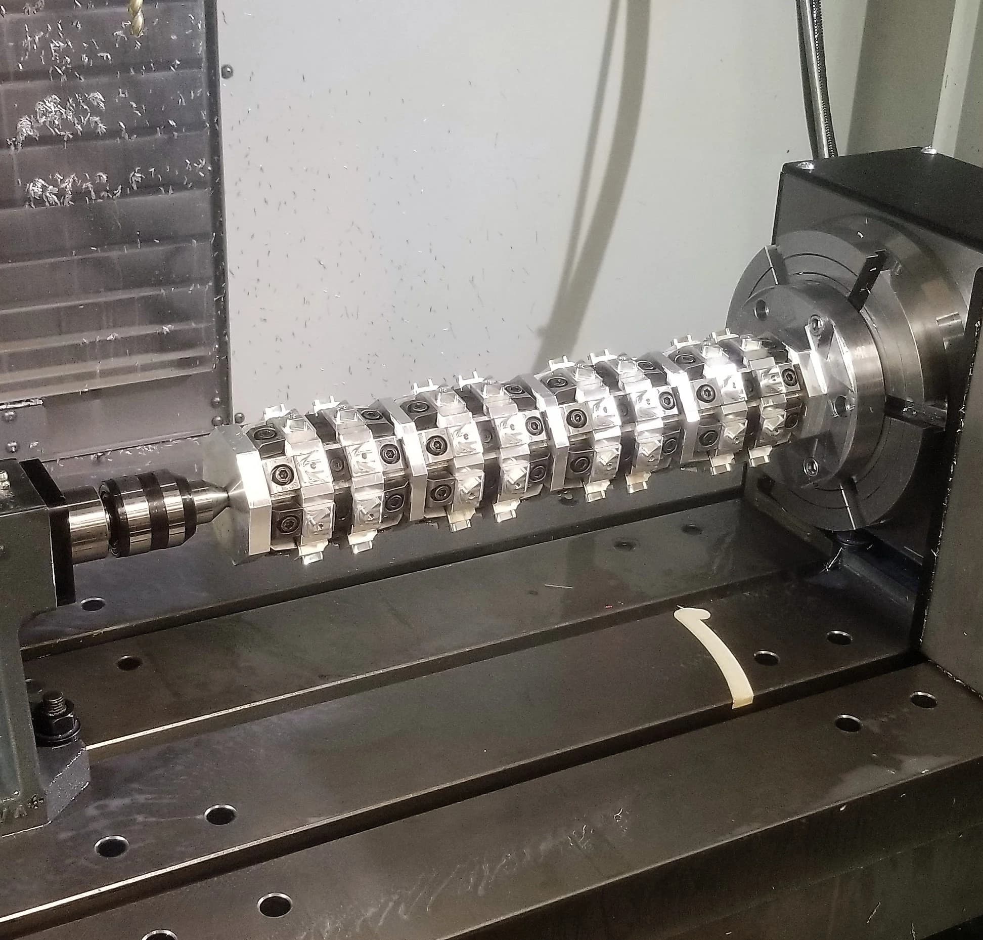 A precision-machined cutter assembly turning in a CNC lathe chuck at Centerline Inc.